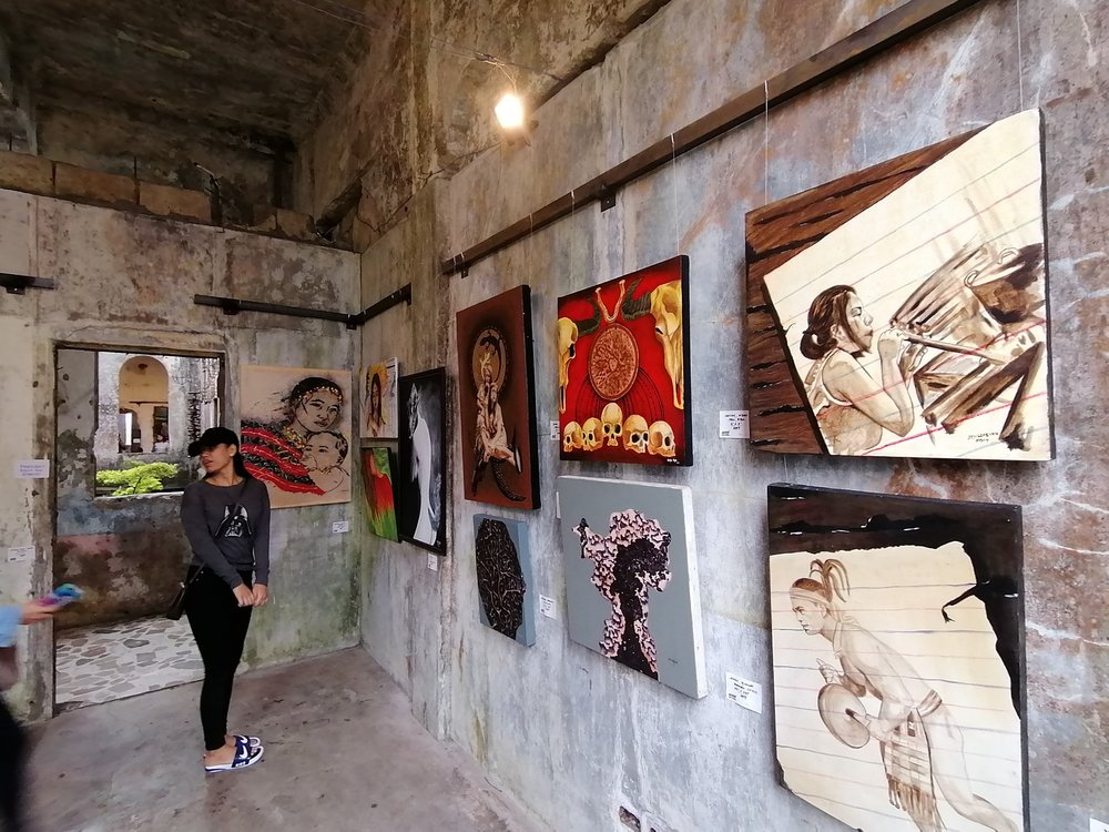 Girl looking at the paintings in dipslay