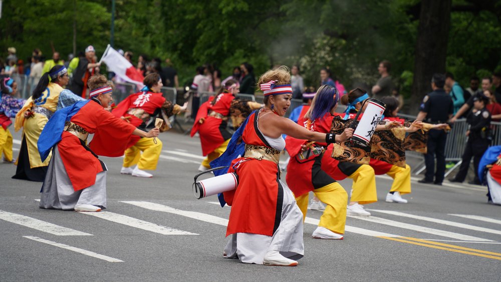 people in costume dancing on street