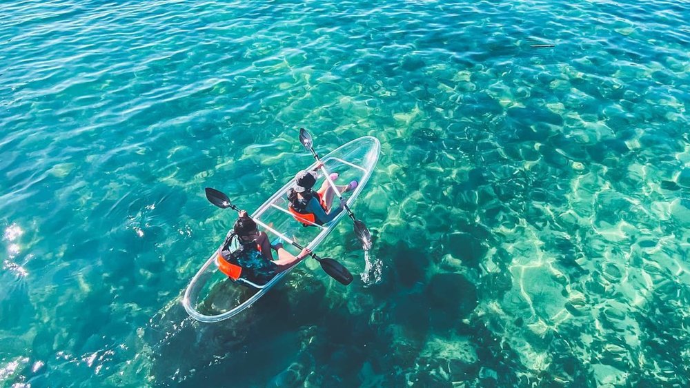 two people on a transparent kayak