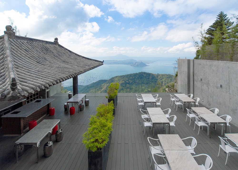 An outdoor lounge with tables and chairs