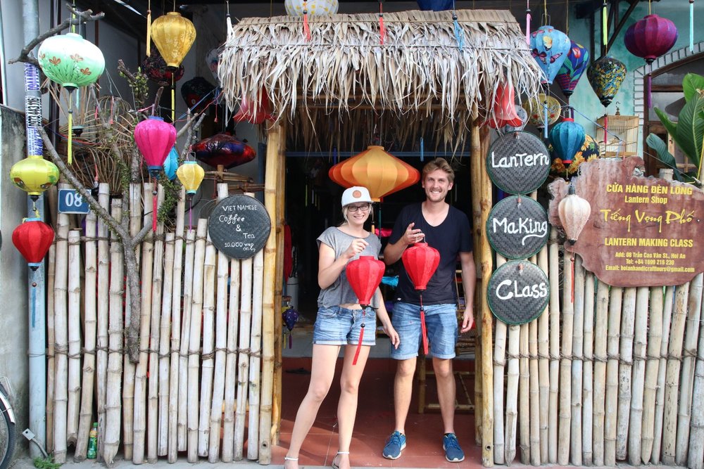A man and woman holding red lanterns