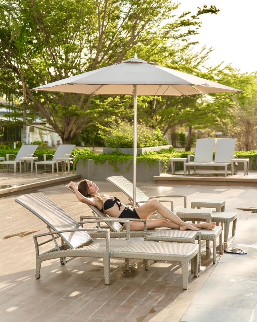 A woman relaxing near the pool