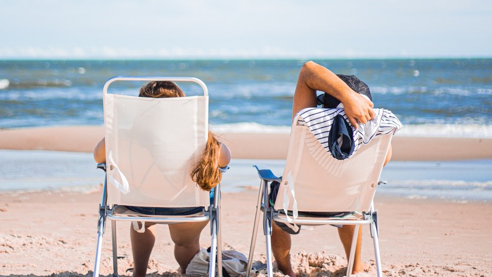 two people chilling by the beach