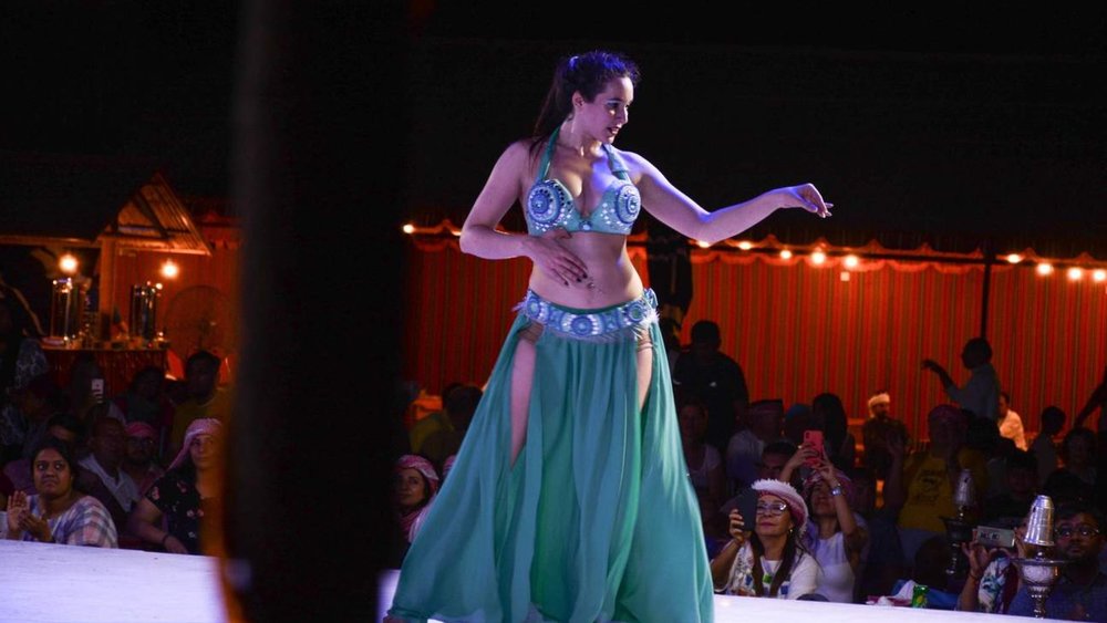 a woman belly dancing on stage
