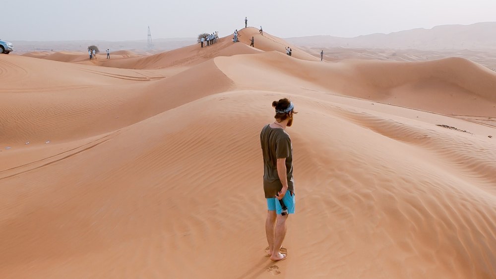 a man standing on the desert