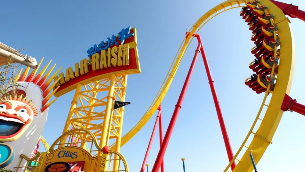 roller coaster with sign saying "hair raiser"