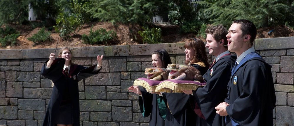 People singing with big frog