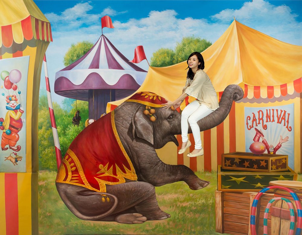 Girl riding the elephant trunk