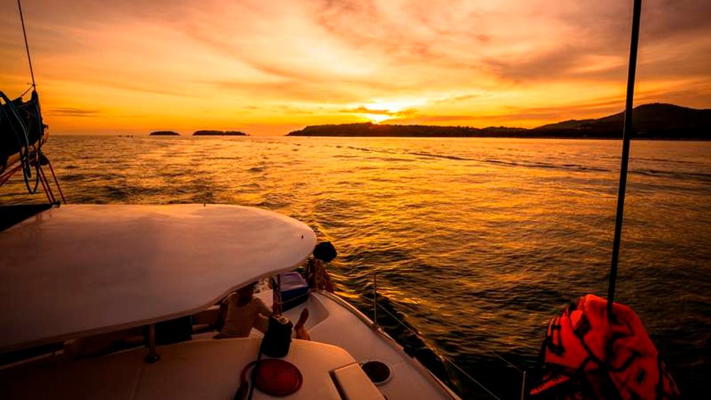 Enjoy a romantic sunset dinner as newlyweds on the Promthep Cape while sailing aboard a luxurious Catamaran Yacht.