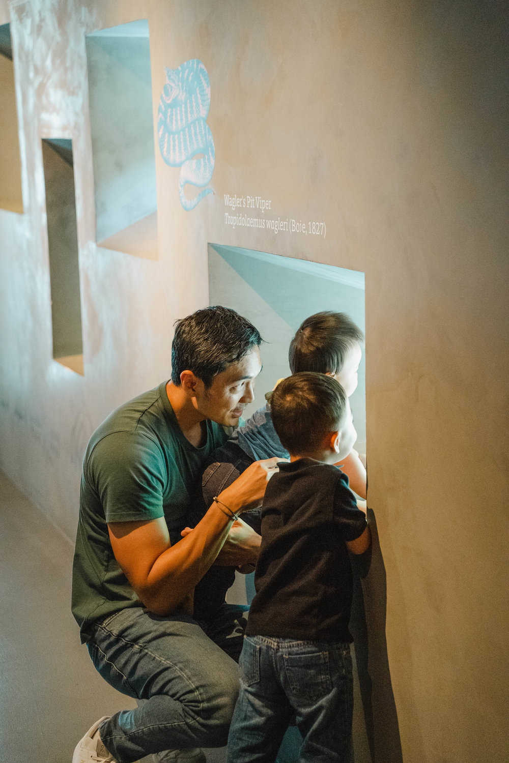 father with two sons in museum