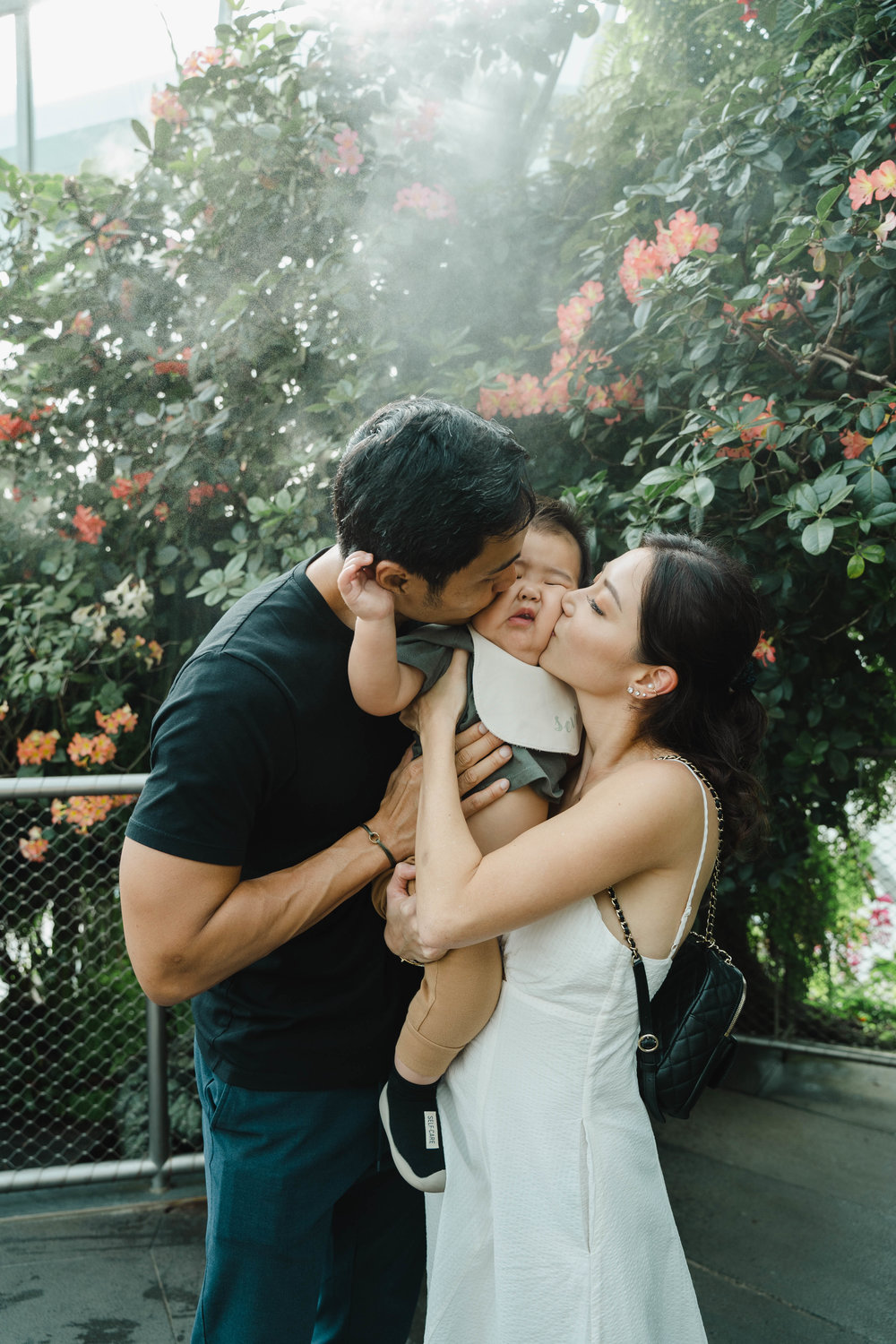 parents kissing baby