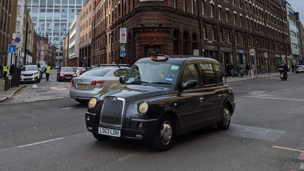 London’s black cabs are a symbol of the city's history and a reliable way to get around! Credits to Richard Haas on Unsplash.