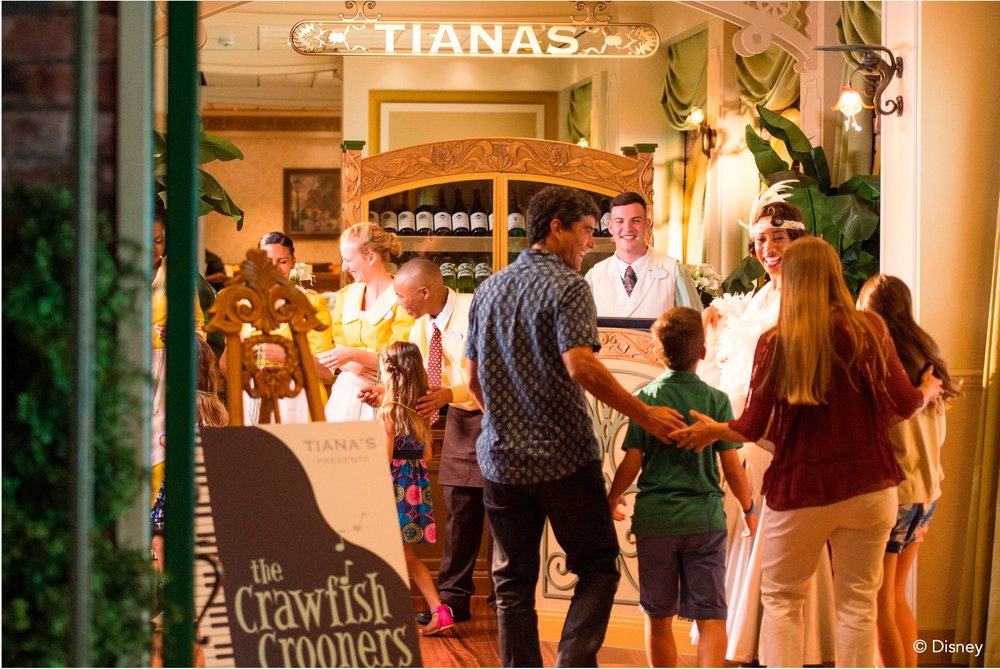 a family entering a disney-themed restaurant