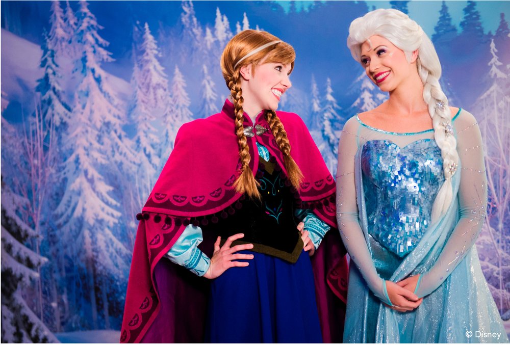 two performers dressed as Anna and Elsa from Frozen