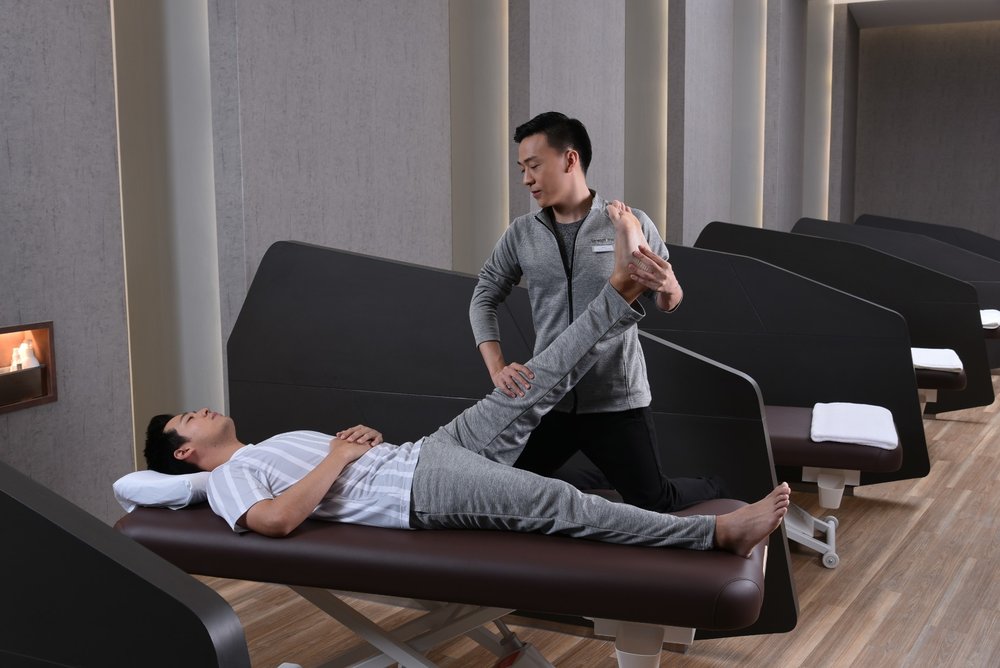 Man stretching a man's leg