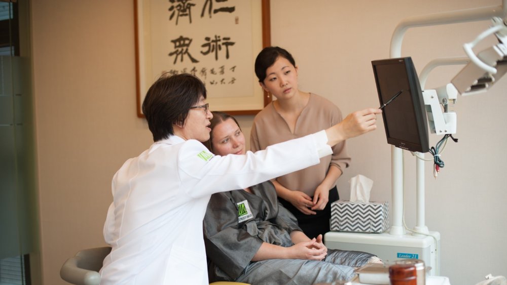 a derma showing the patient what to expect in her treatment