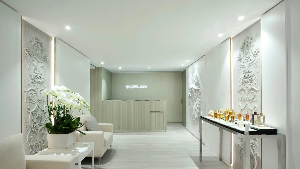 a spa lobby with flowers and white hues as the spa theme