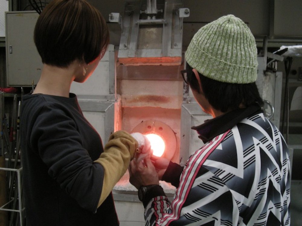 Two people heating something