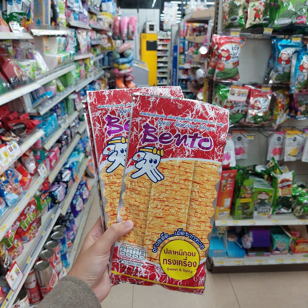 Person holding packs of cuttlefish snacks