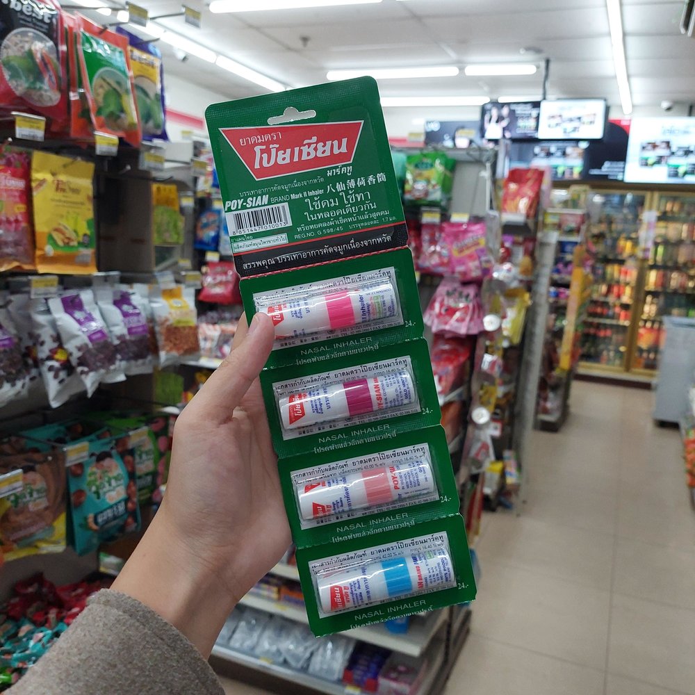 Person holding a pack of nasal inhalers