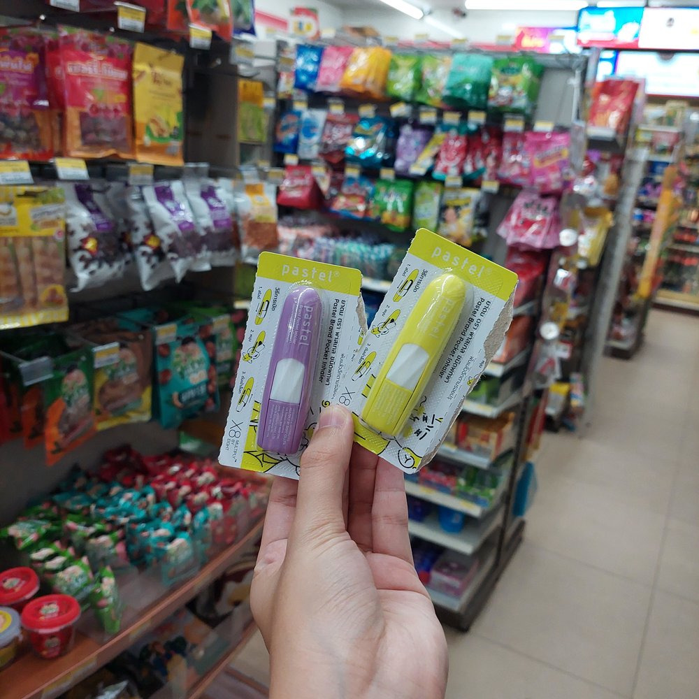 Person holding pastel nasal inhalers