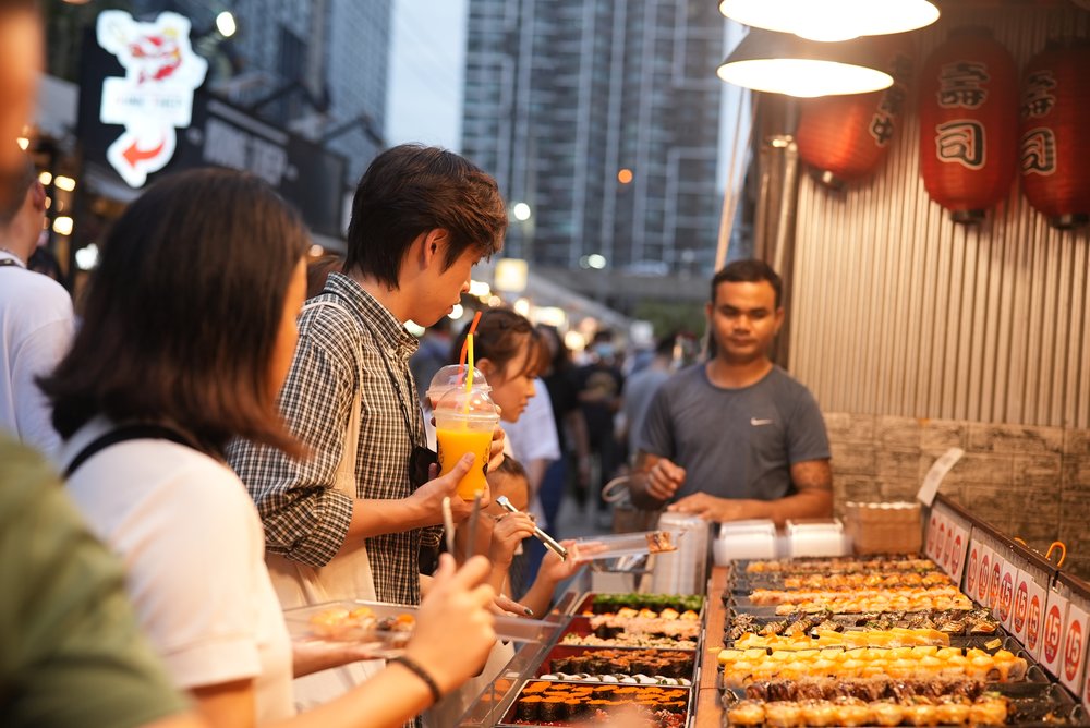 Man and woman looking at sushi