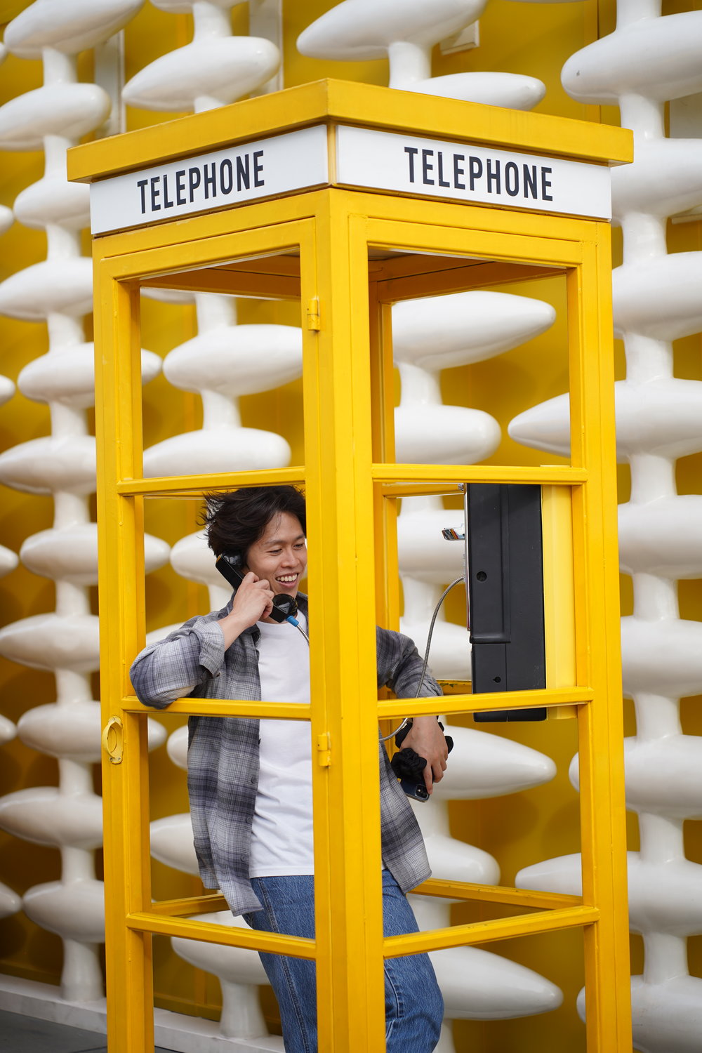 Man inside a yellow phone booth