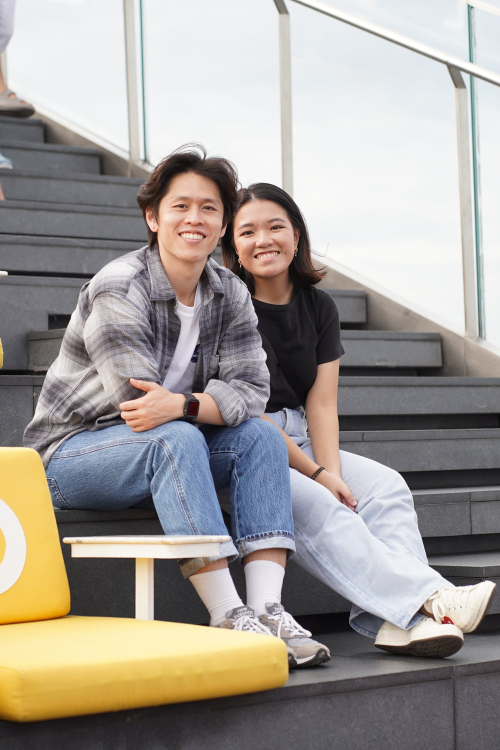 Man and woman sitting and smiling at the camera