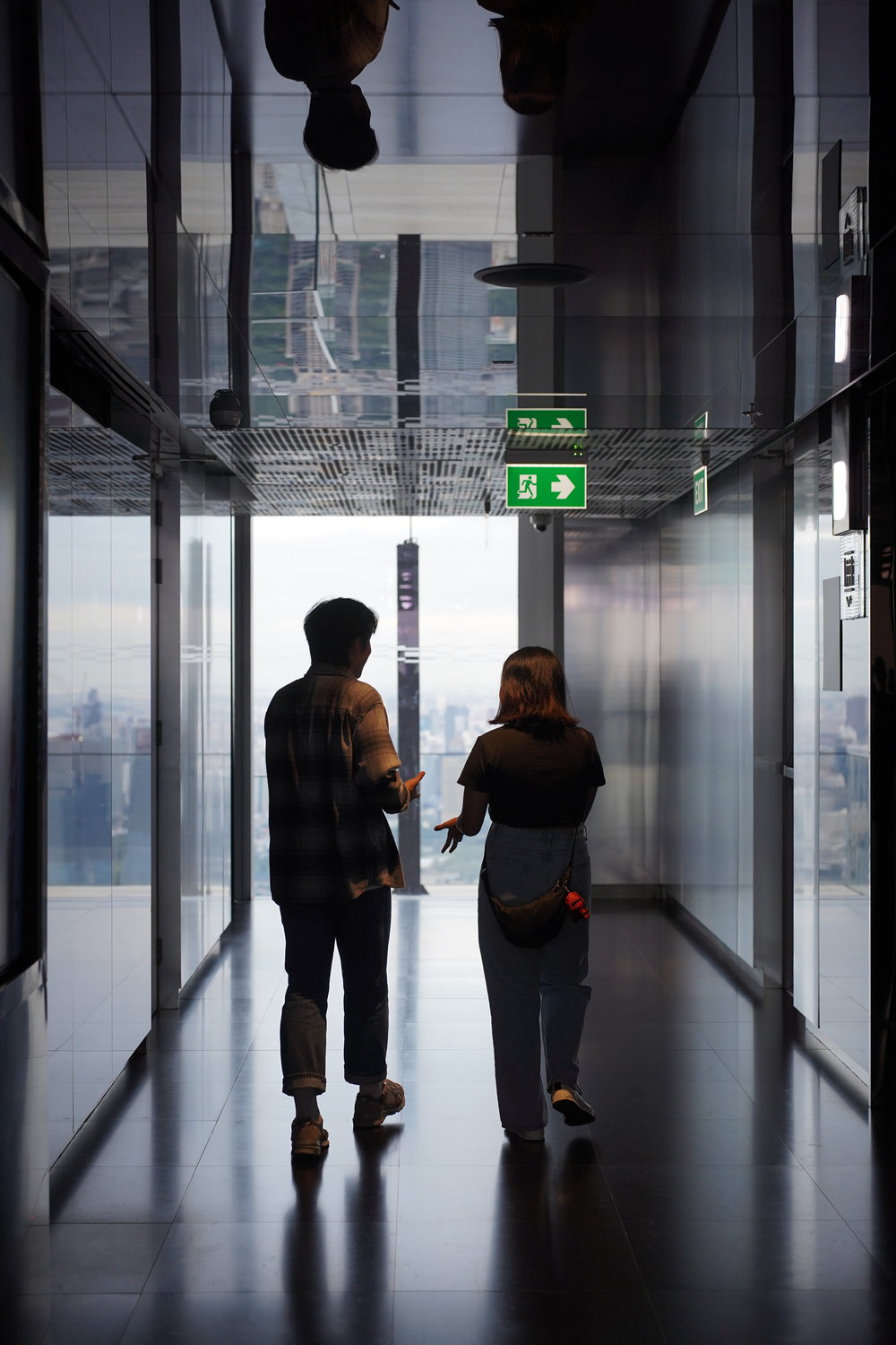 Man and woman talking and walking by the elevator