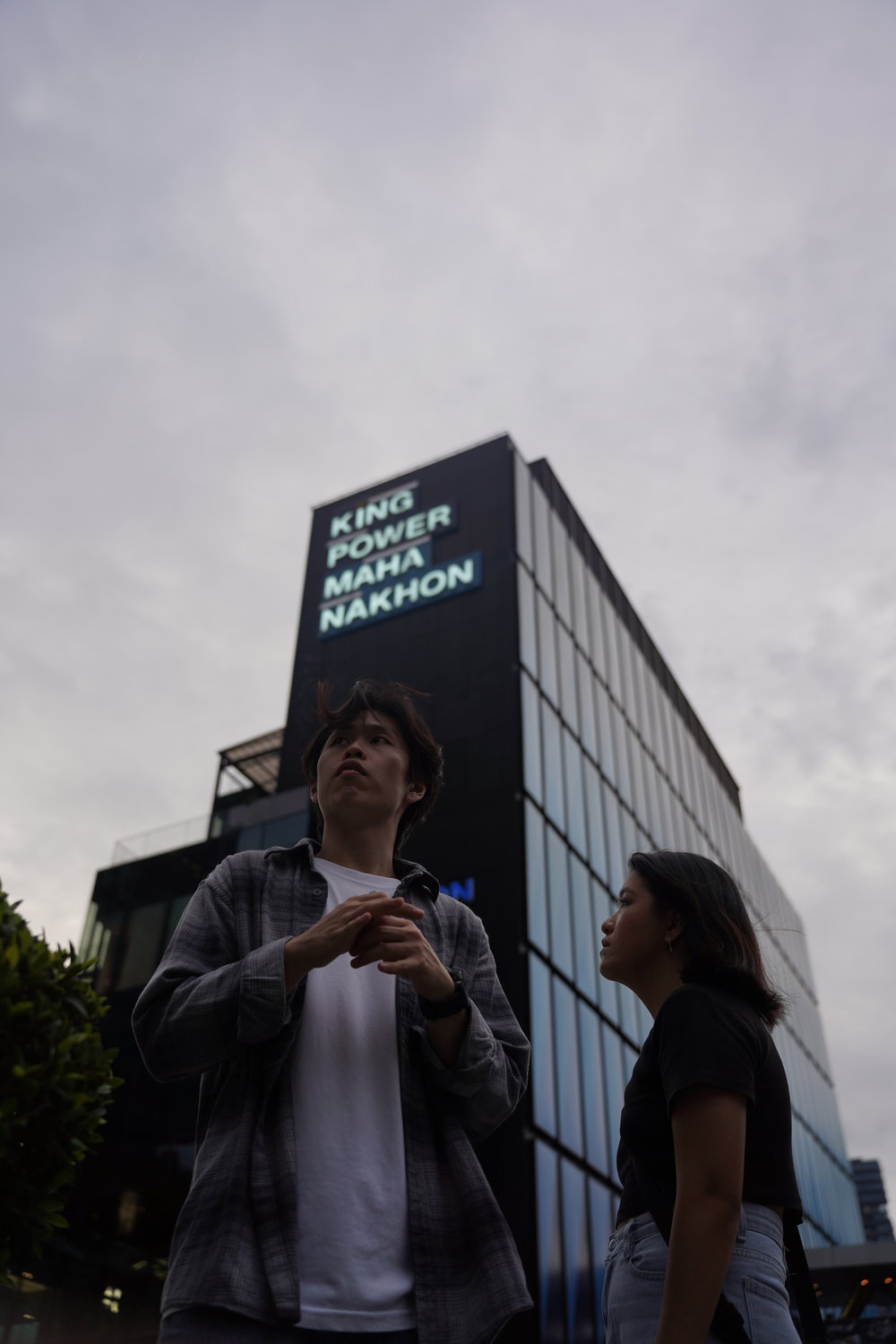 Man and woman standing outside King Power Mahanakhon