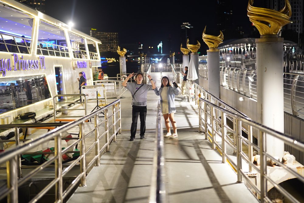 Man and woman standing by a boat