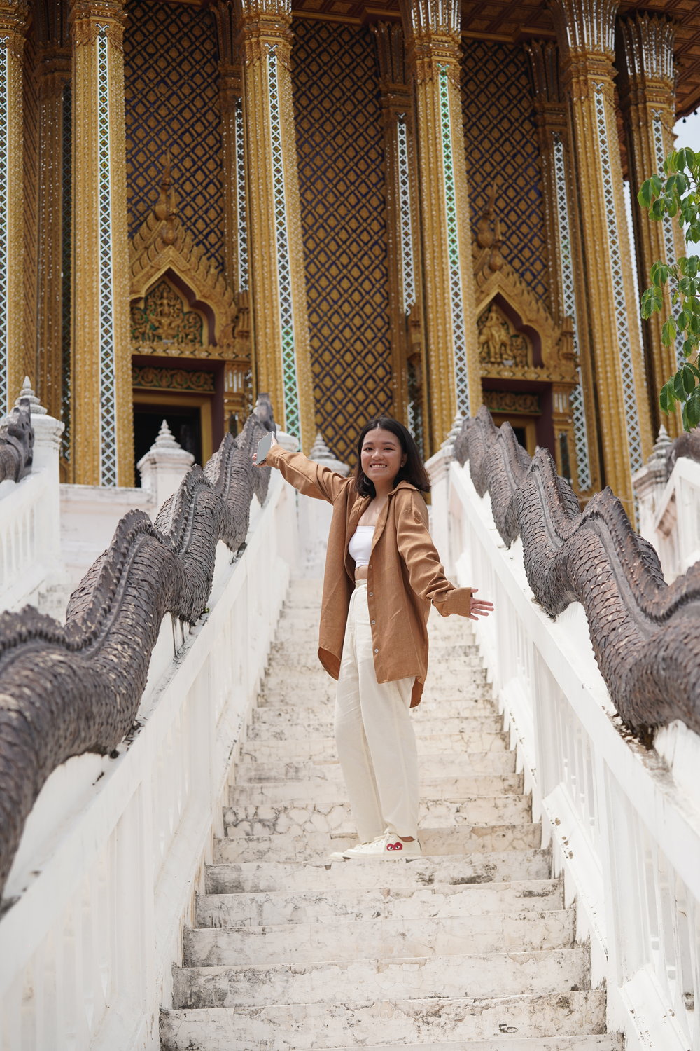 Woman smiling at the camera in front of a temple
