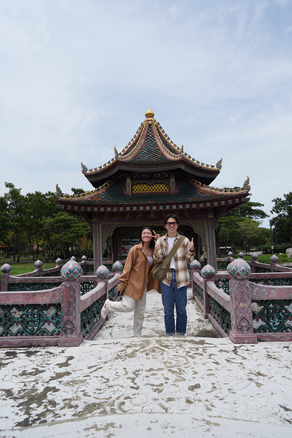 Man and woman smiling in front of a temple