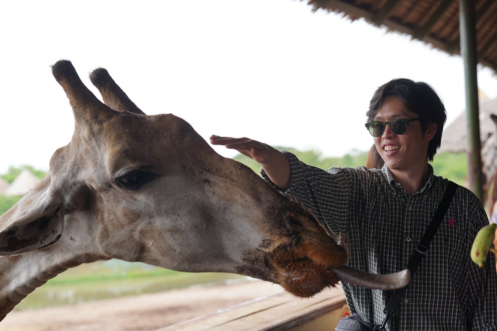 Man petting a giraffe