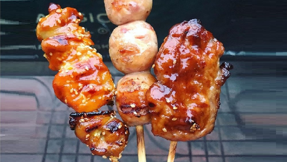 Savoring the ultimate trio of street food perfection: Pork, Chicken, and Sausage Skewers! Credits: @badtothebite on Instagram
