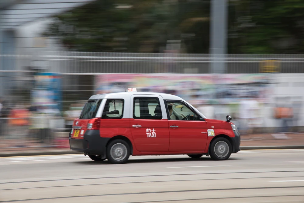 Hong Kong Red Taxi (Photo by Arron Choi on Unsplash)