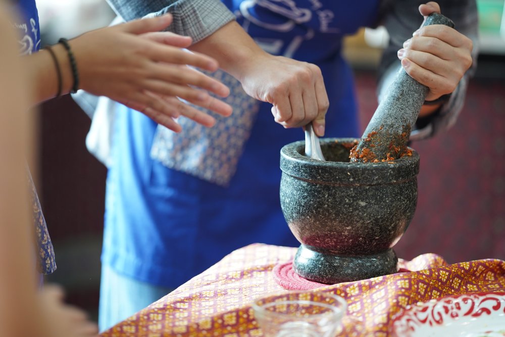 Person crushing ingredients to make paste