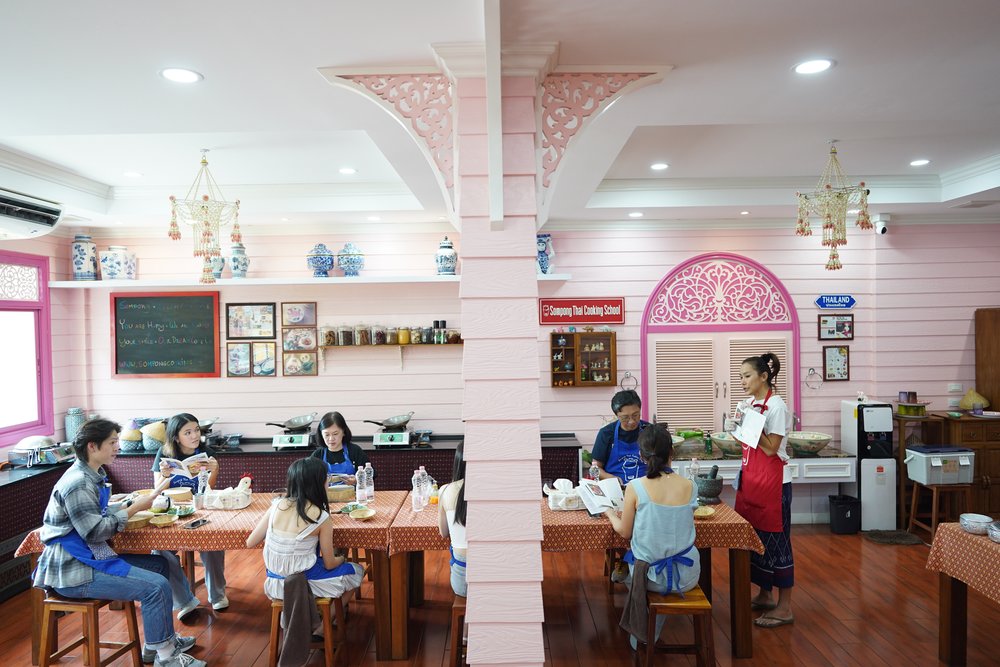People seated and listening to the chef