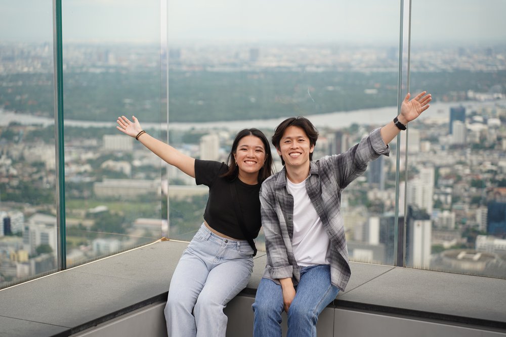 Man and woman happily seated on the skywalk bench