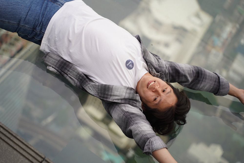 Man lying down on the skywalk