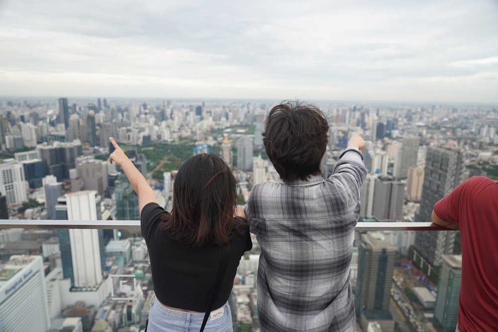 Man and woman pointing at the buildings