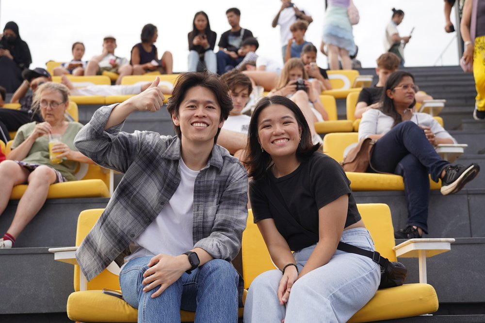 Man and woman sitting on yellow cushions