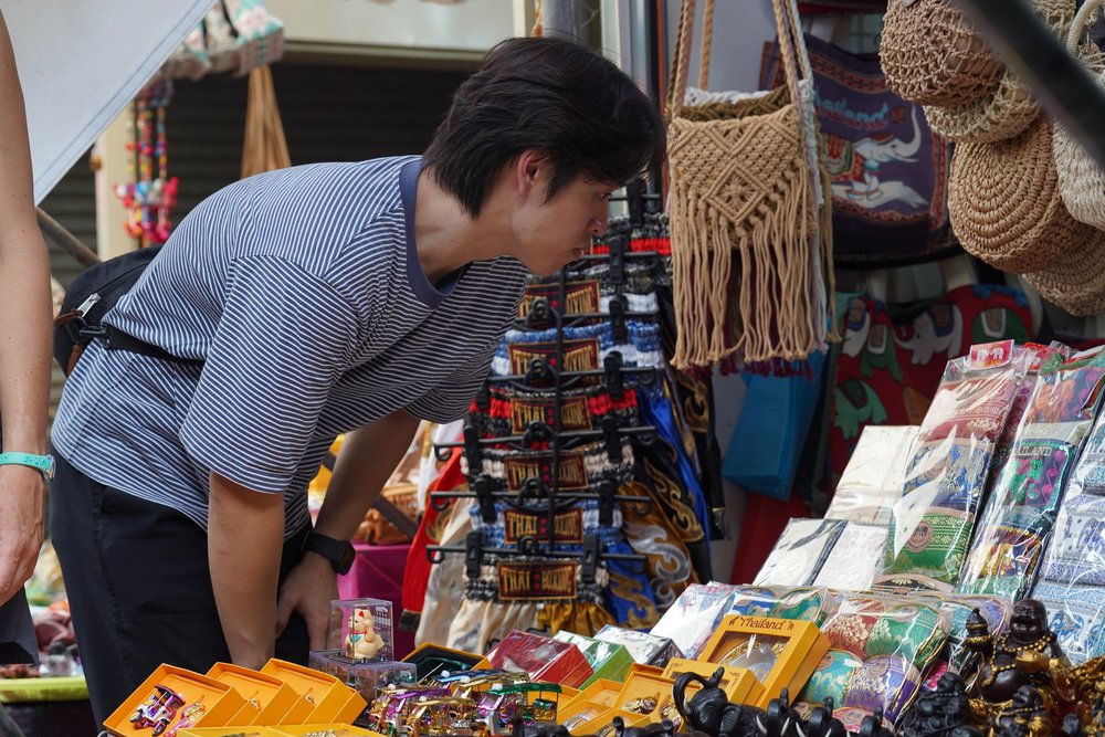 Man looking at the items on display at a store