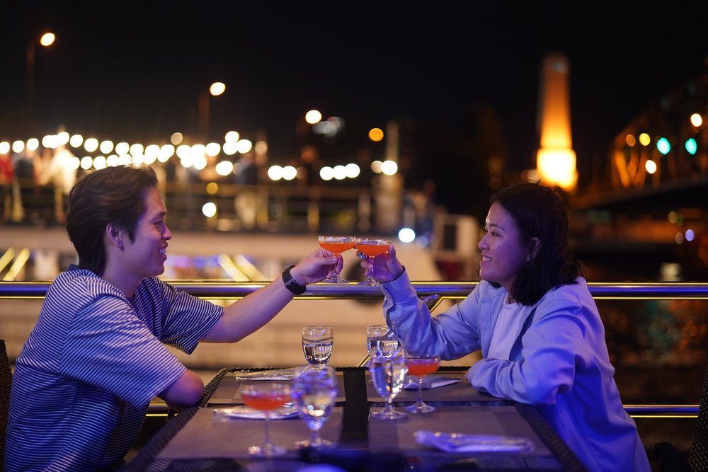 Man and woman happily clinking their glasses