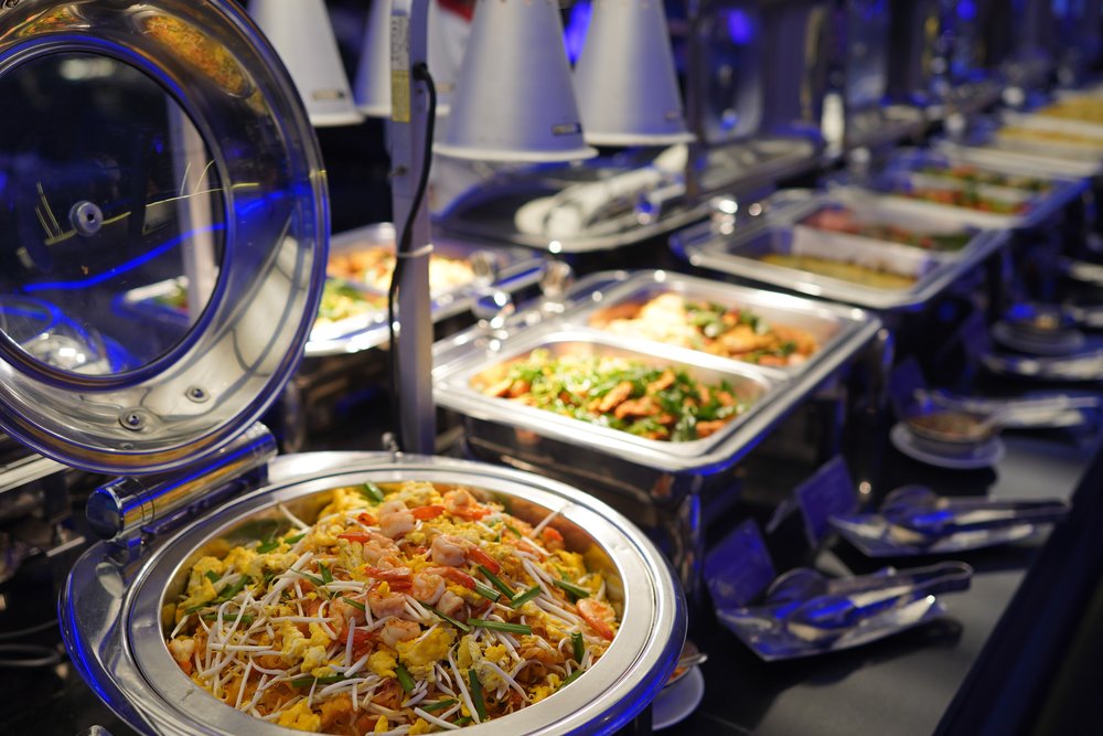Different dishes lined up at a buffet