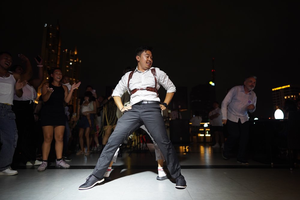 Man dancing on the dance floor surrounded by people