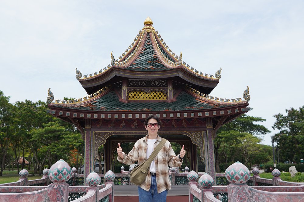 Man smiling in front of a temple