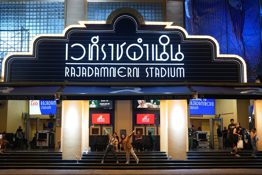 Man and woman outside a stadium