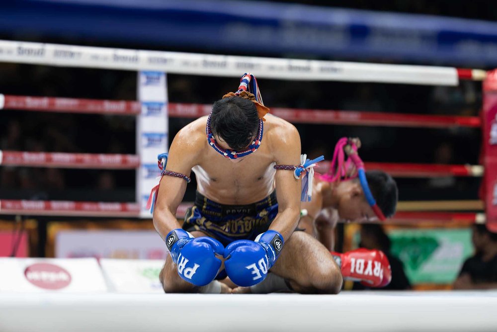 Muay Thai fighters bowing inside the ring