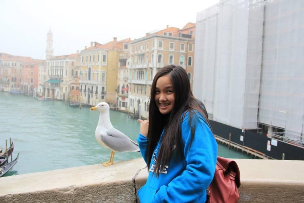 girl posing along a bridge in venice